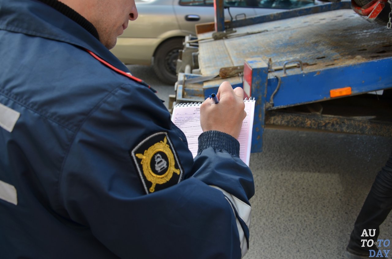 Сотрудник патрульной службы регистрирует аварию Сотрудник патрульной службы регистрирует аварию